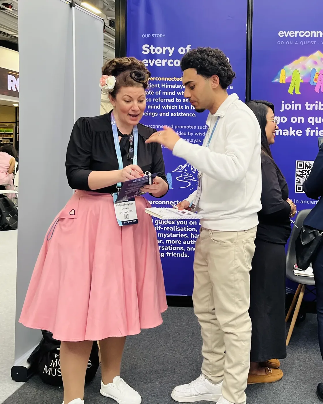 A conversation at the stand, in front of the story wall
